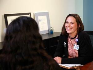 Genetic Counselor Melanie Baxter meets with a patient